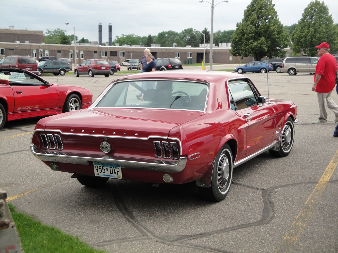 Rear view of vintage Mustang with iconic triple tail lights and chrome bumper