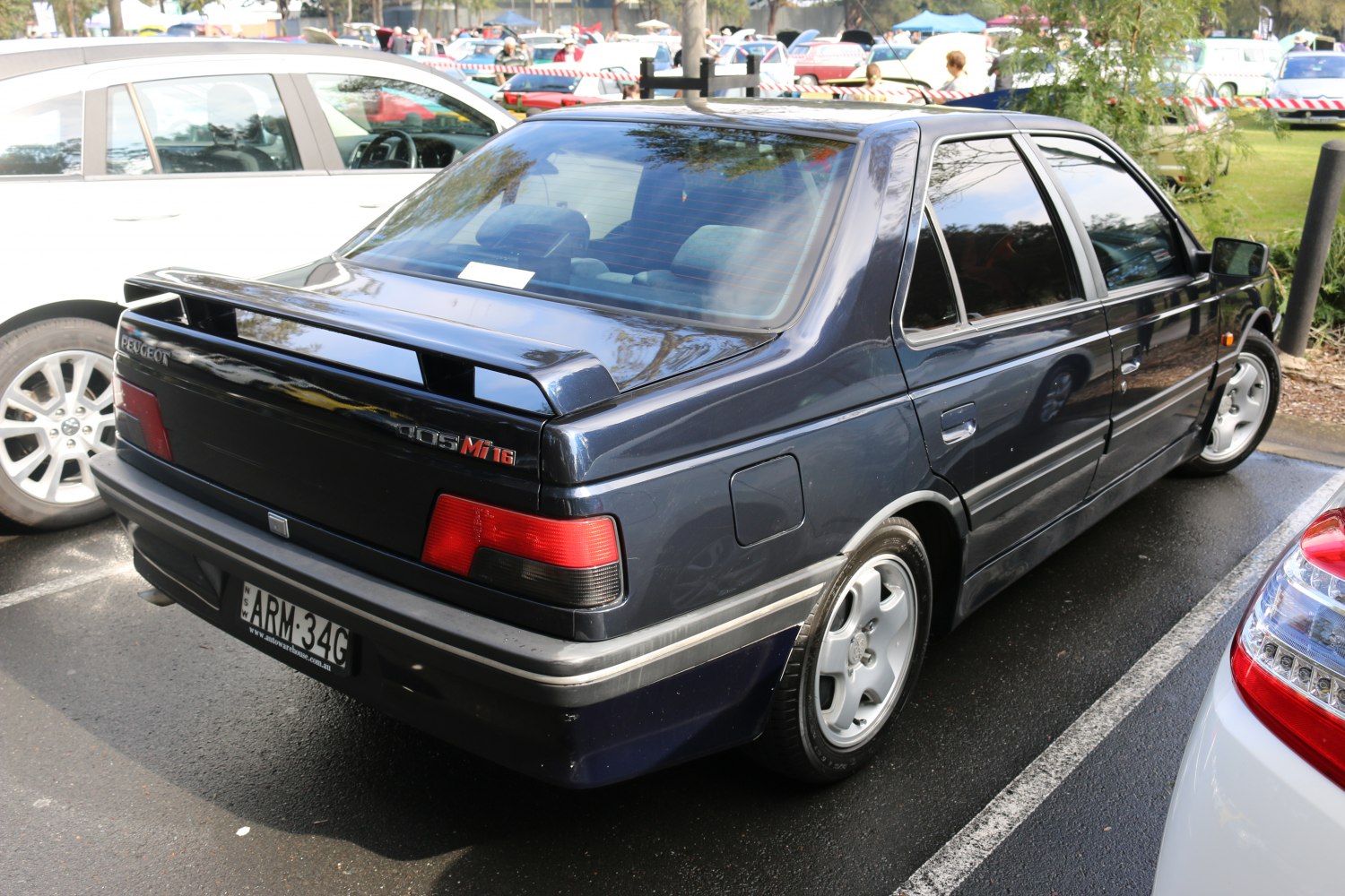 Rear side with black spoiler and alloy wheels