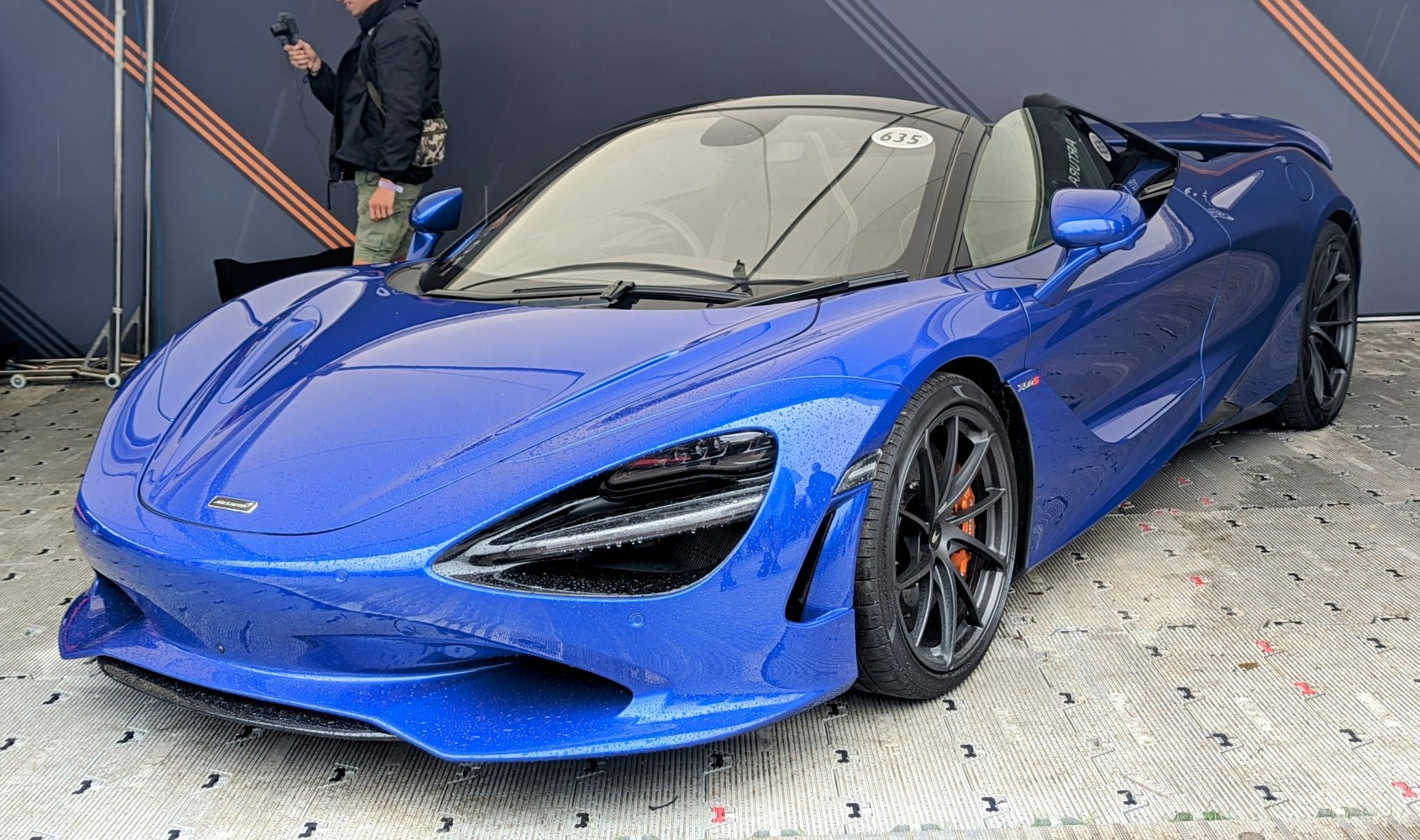 Blue convertible with aerodynamic front and aggressive headlights