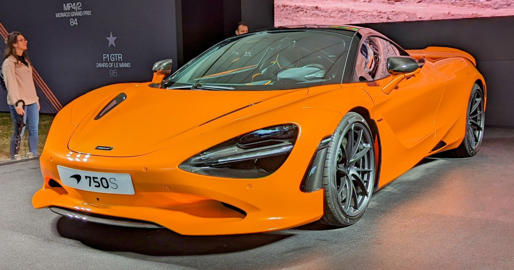 Orange sports coupe front fascia with black wheels and carbon fiber accents