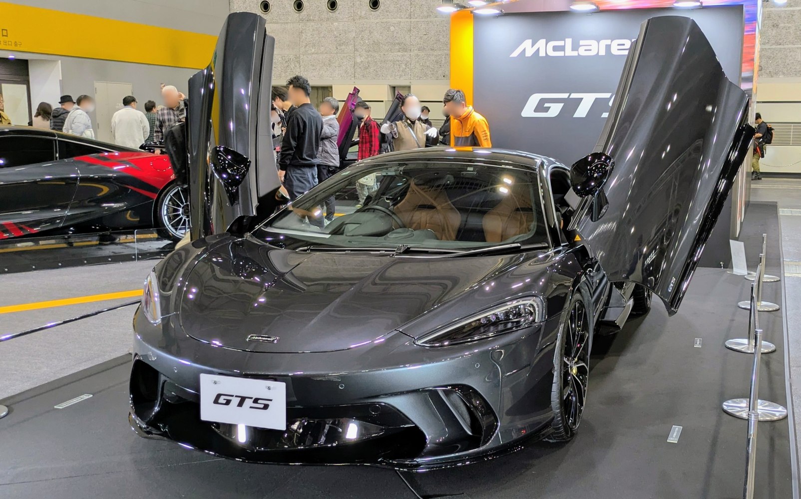 Front view of a sports coupe with open dihedral doors