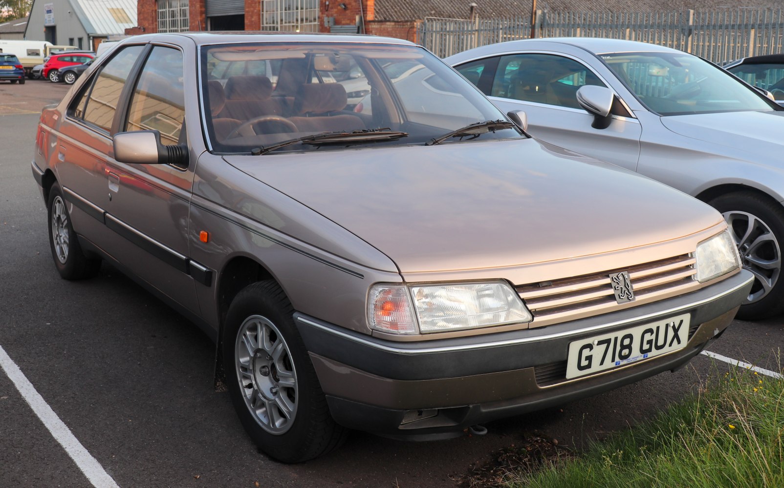 Front and side angled view of a four-door sedan with clear headlights and grille.