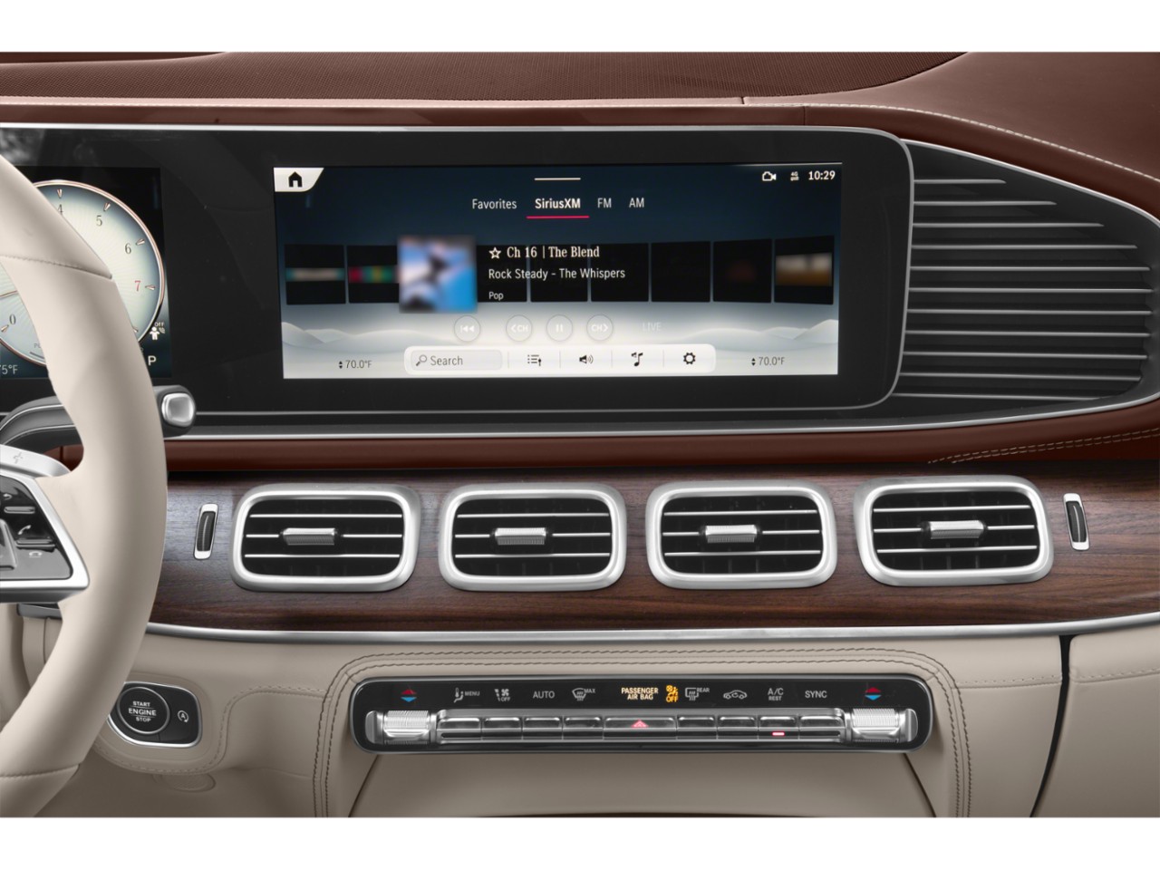 Digital dashboard and wooden trim air vents in luxury SUV interior