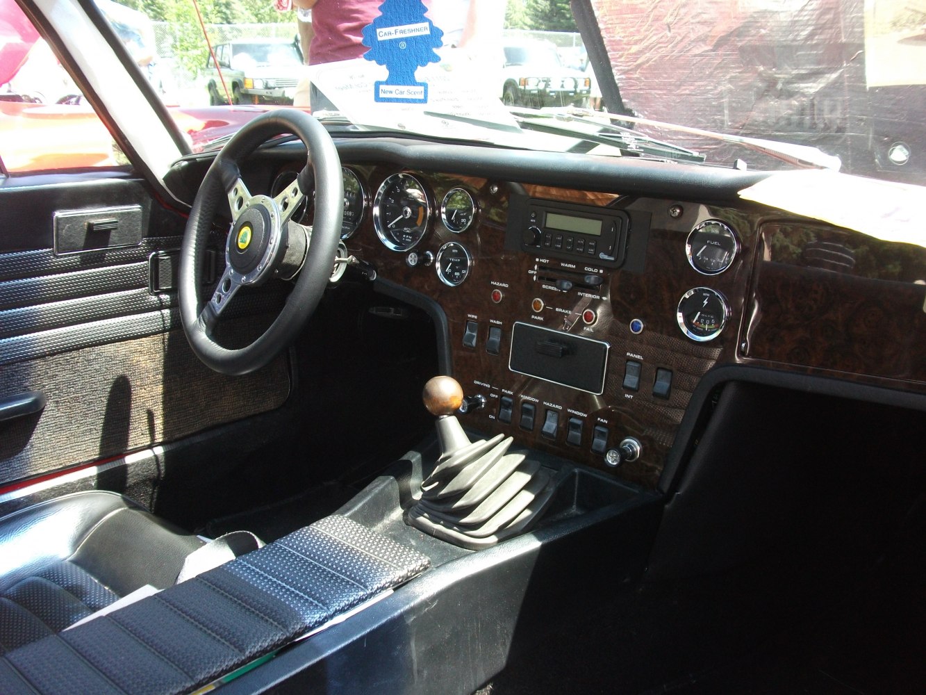 Classic vintage car interior with wood dashboard and manual gear shift