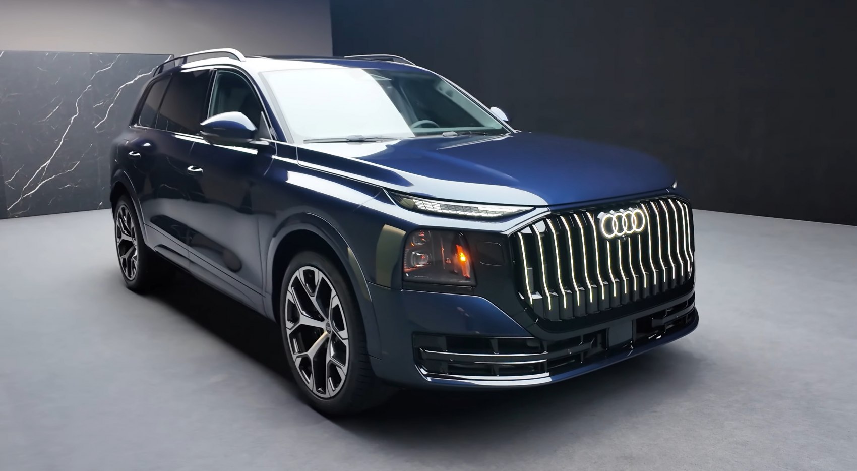 Bold illuminated vertical grille and sleek LED headlights on SUV front