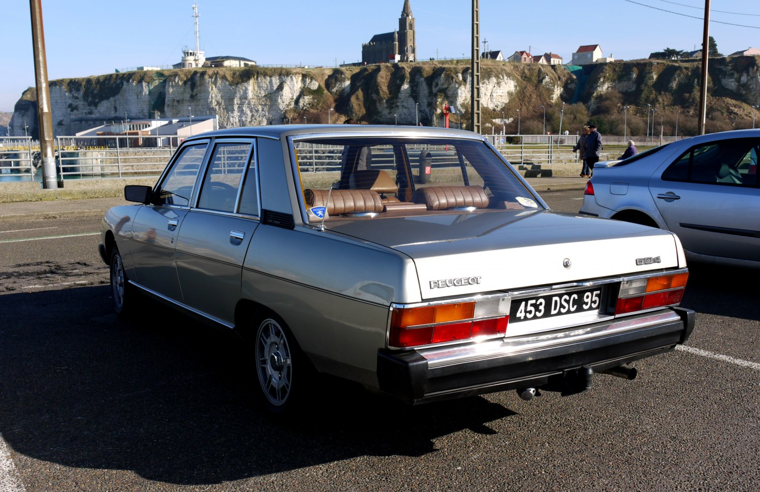Rear side view of classic sedan with vintage tail lights and badge