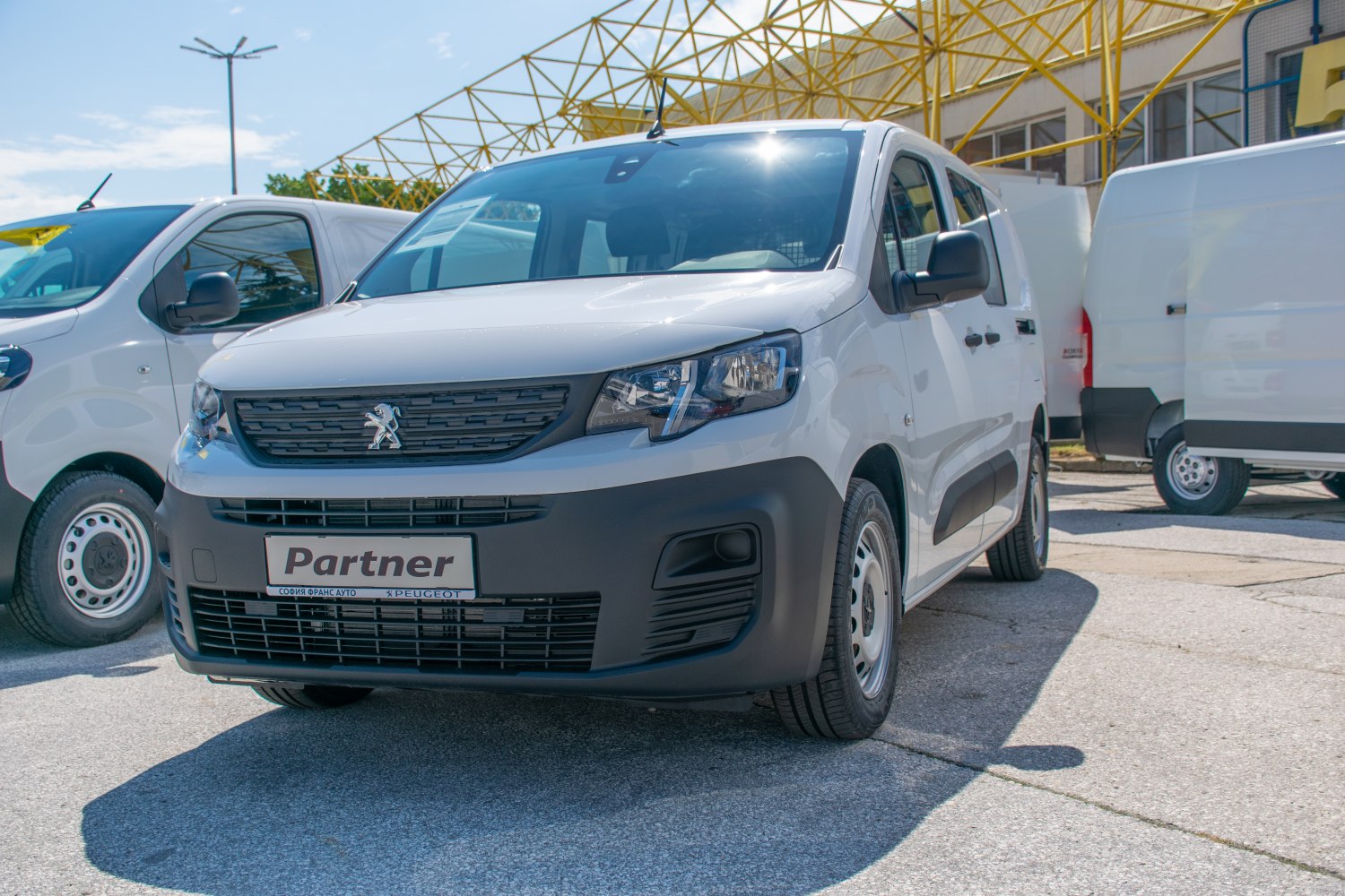 Front view of a white utility van with grille and headlights