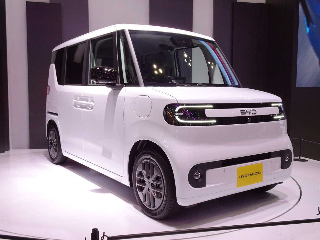 LED-lit compact electric microvan with boxy design and modern features.