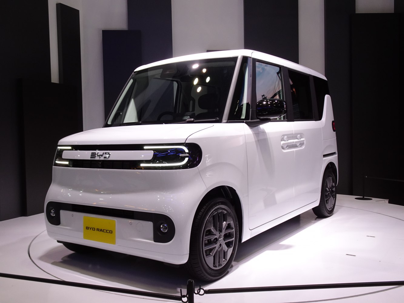 Compact electric microvan with horizontal LED headlights and boxy design