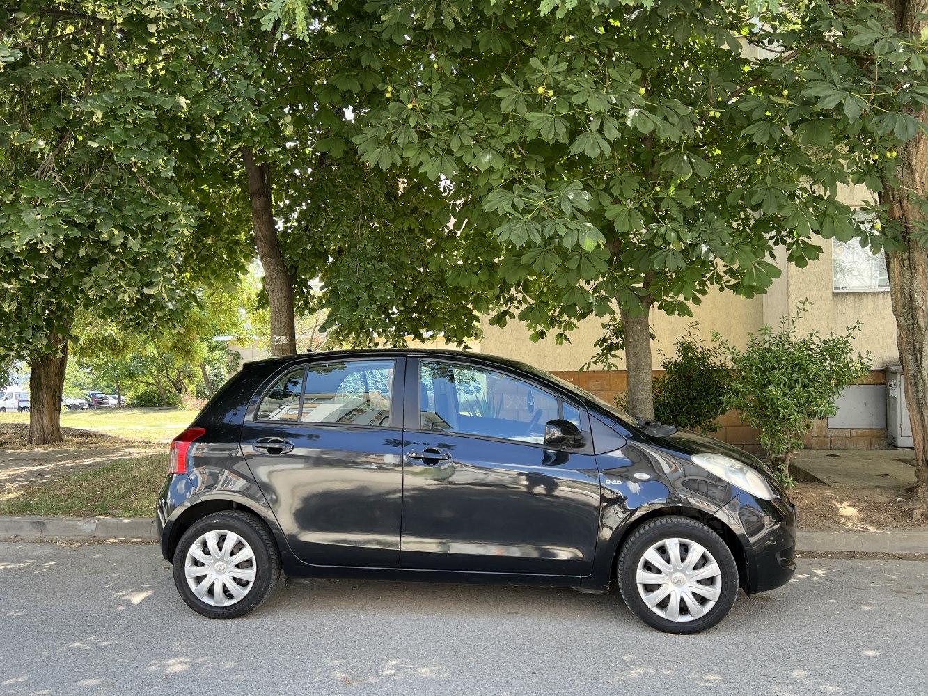 Compact five-door black hatchback side profile with alloy wheels