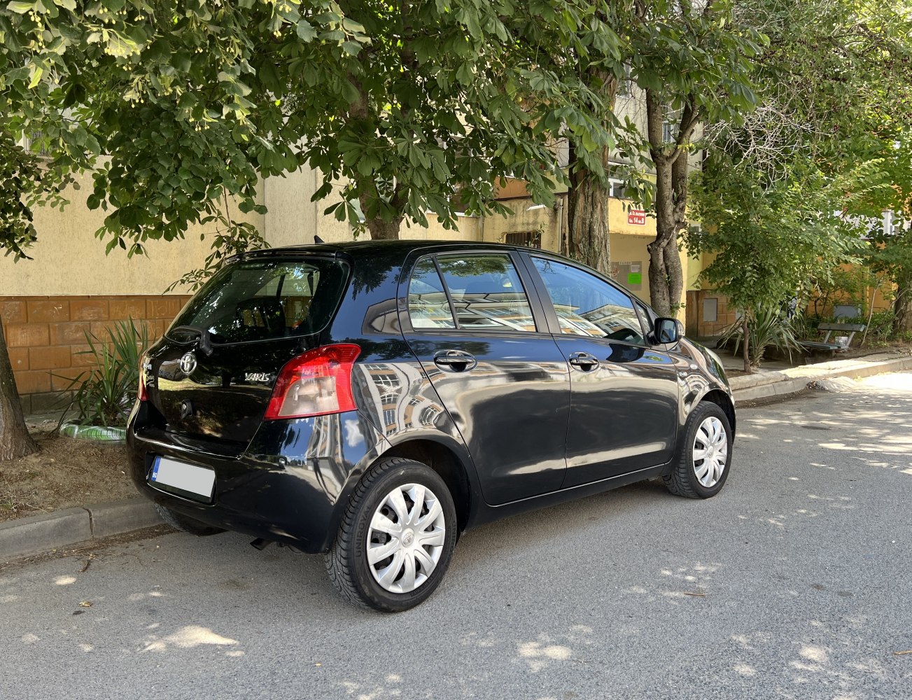 Rear and side view of compact five-door hatchback with distinct taillights.