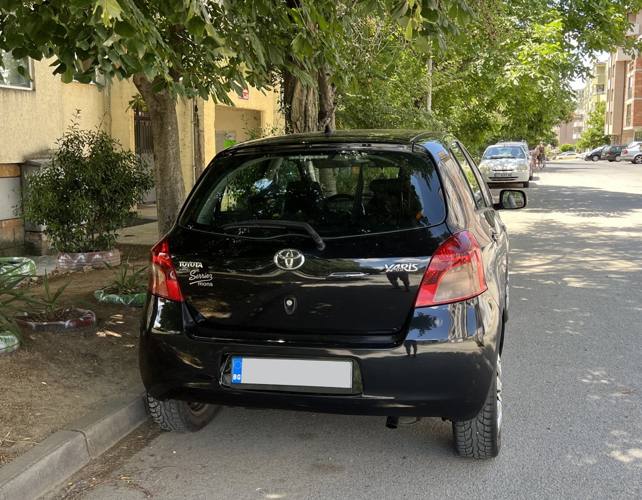 Rear view of a compact hatchback with taillights and rear window wiper