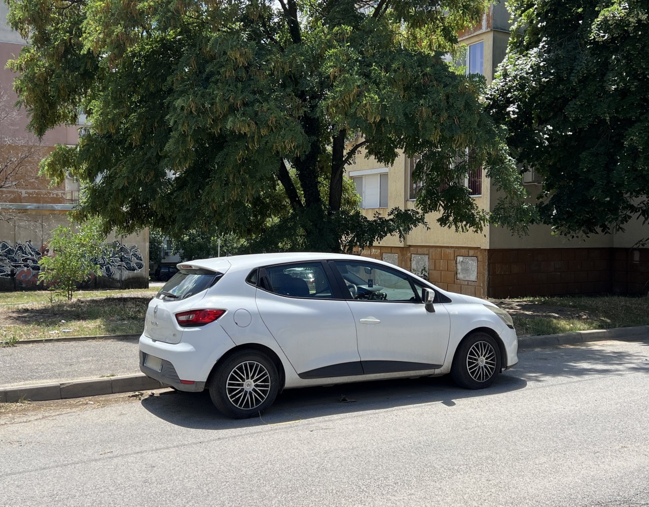 White compact hatchback showing rear and side profile with alloy wheels