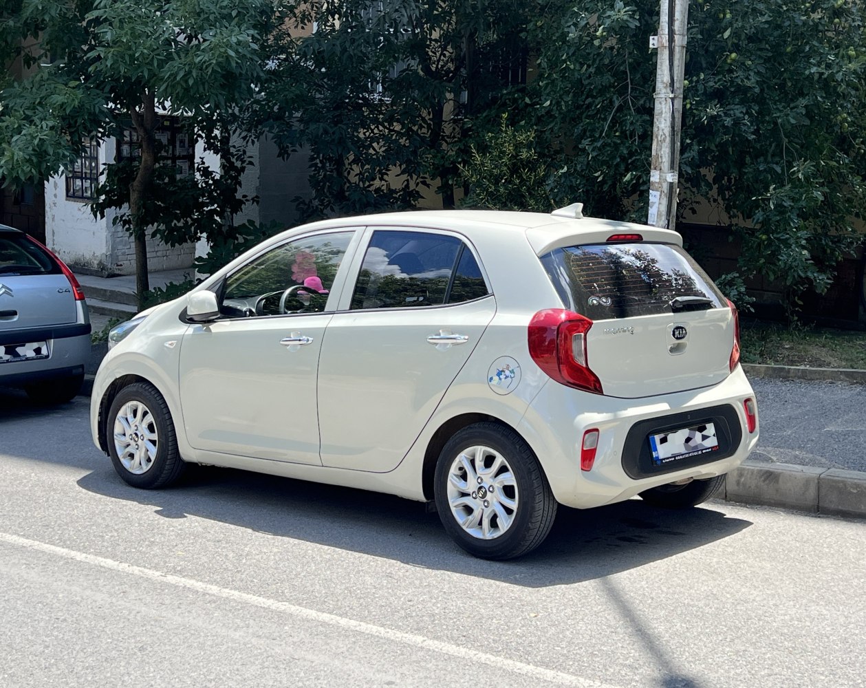 Rear side view of a compact hatchback car with distinctive rear lights.