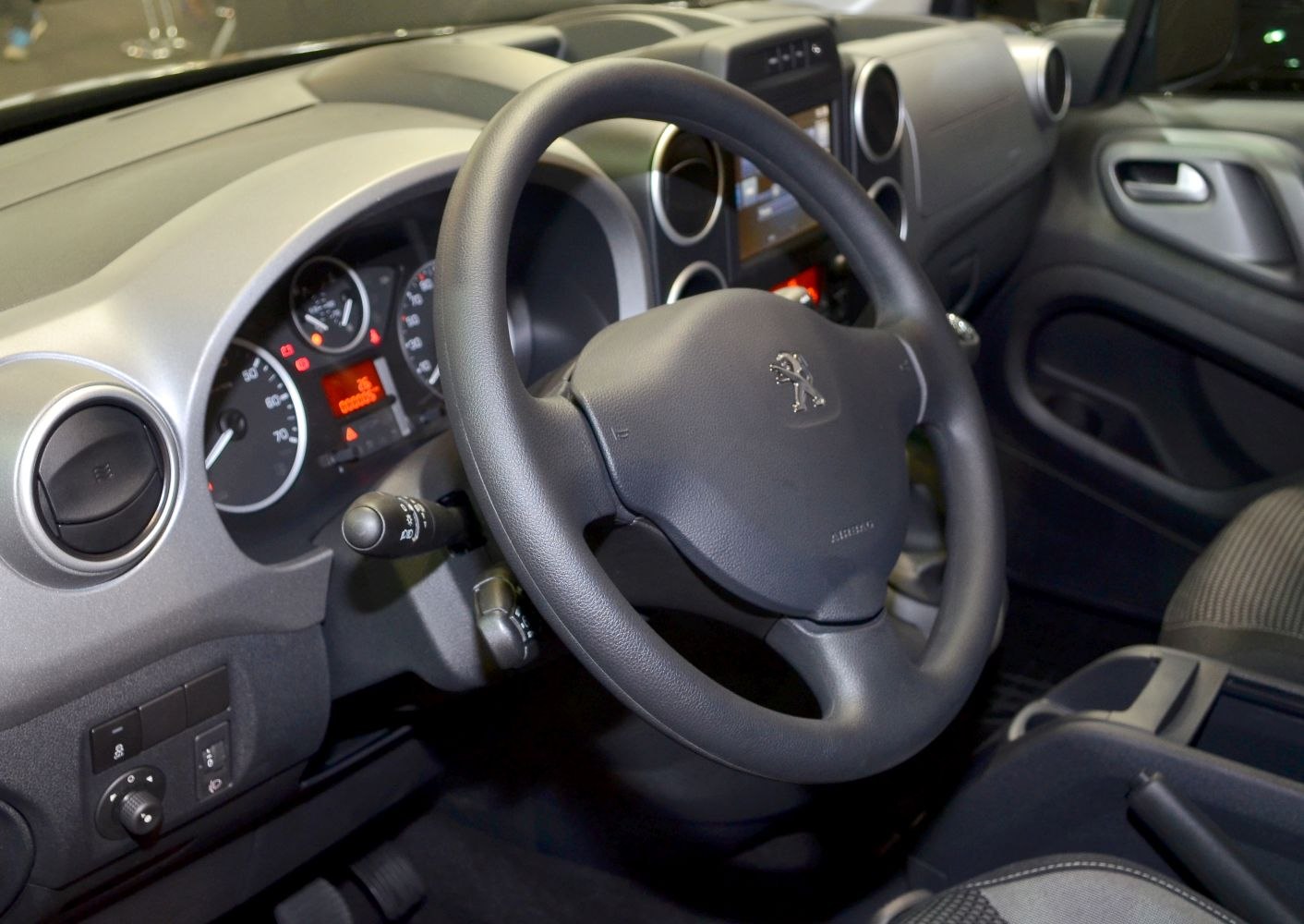 Close-up of steering wheel and dashboard interior with control elements