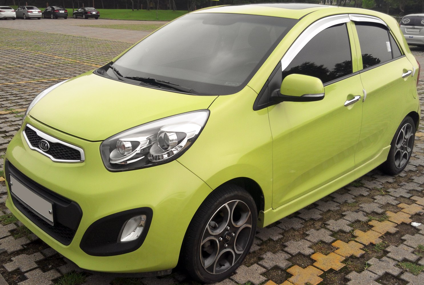 Bright green compact hatchback with alloy wheels and modern headlights