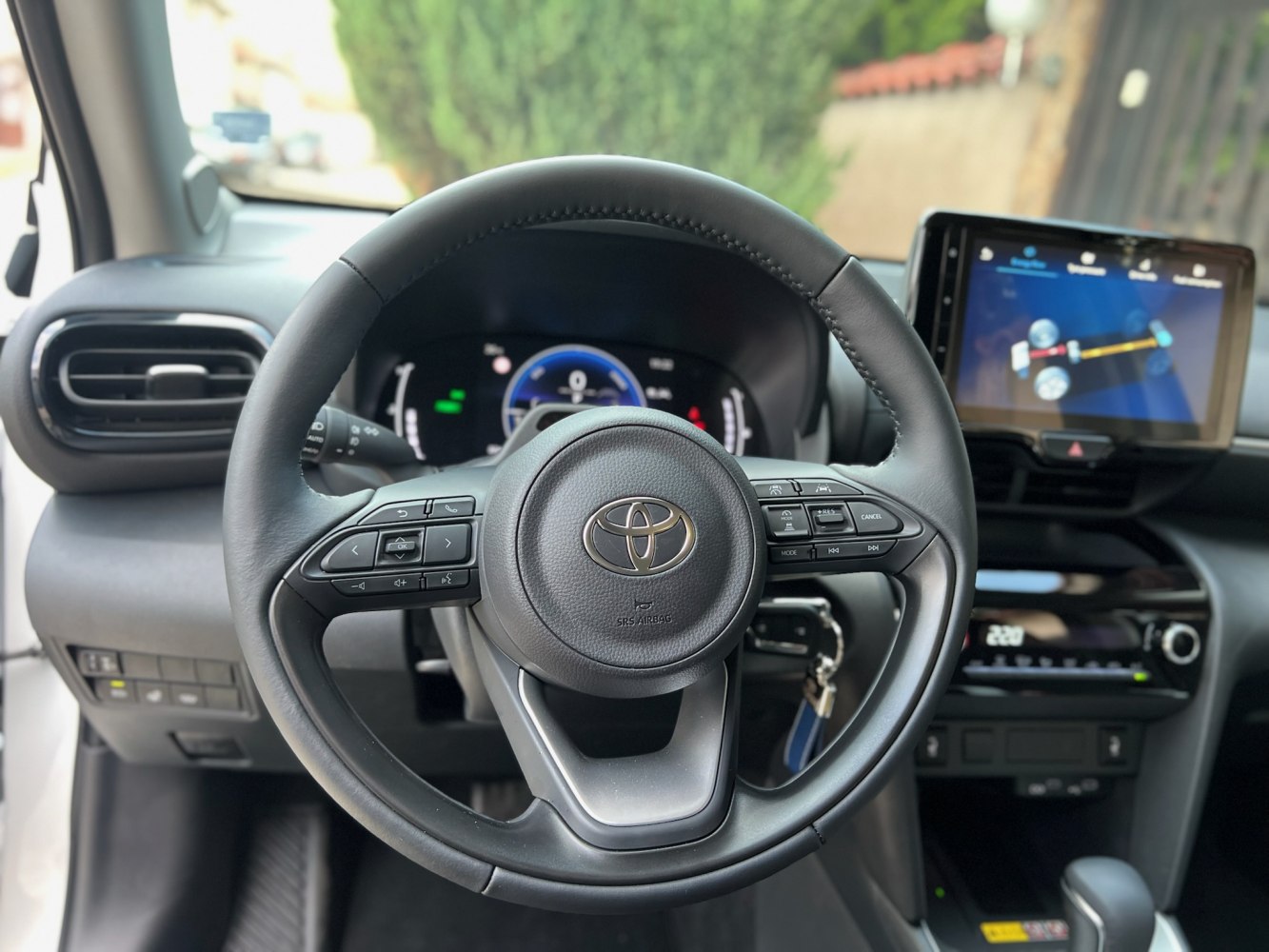 Steering wheel with control buttons, digital instrument cluster, infotainment screen
