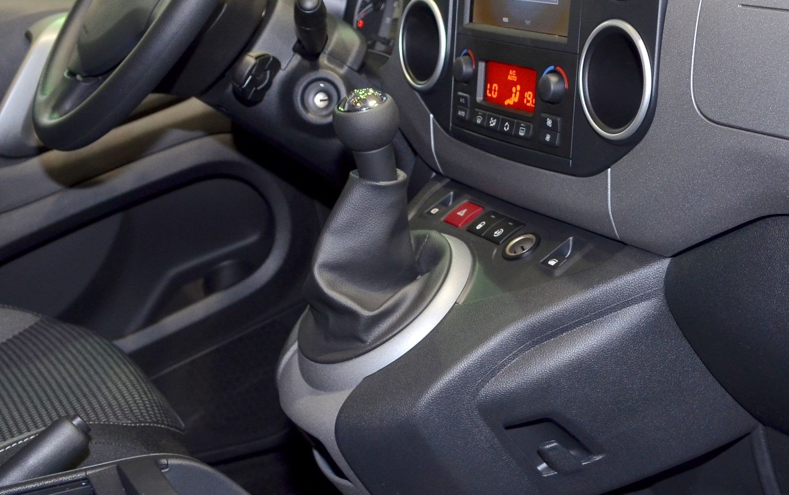 Manual gear shift lever and dashboard climate control in vehicle interior