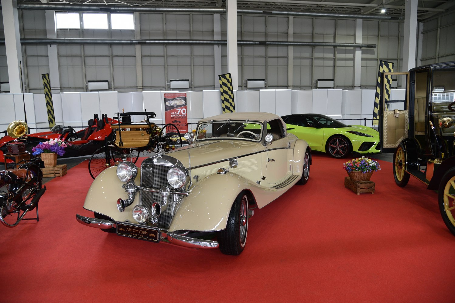 Vintage convertible with prominent chrome headlights and grille