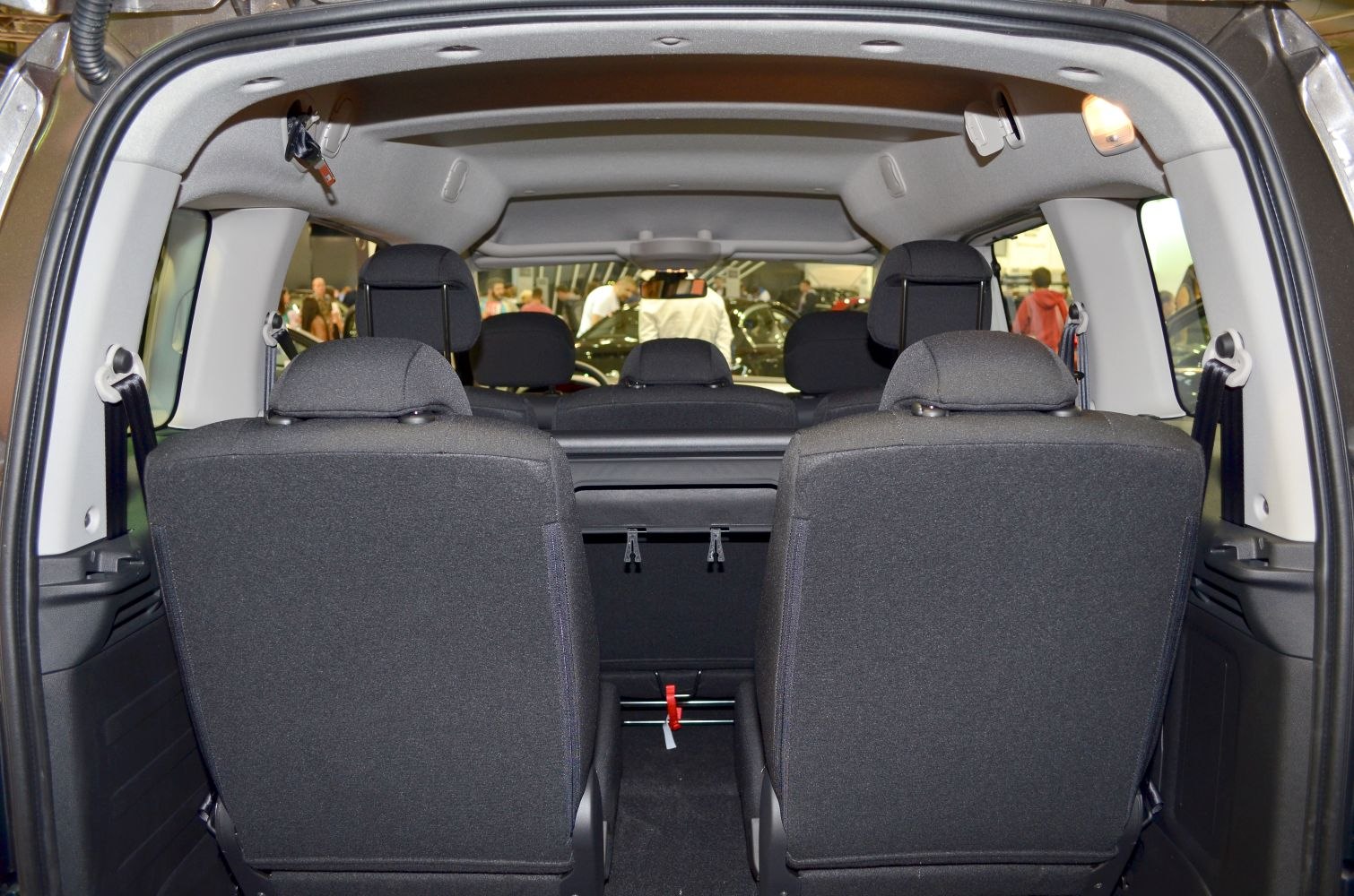 Rear interior showcasing foldable seats and spacious passenger area