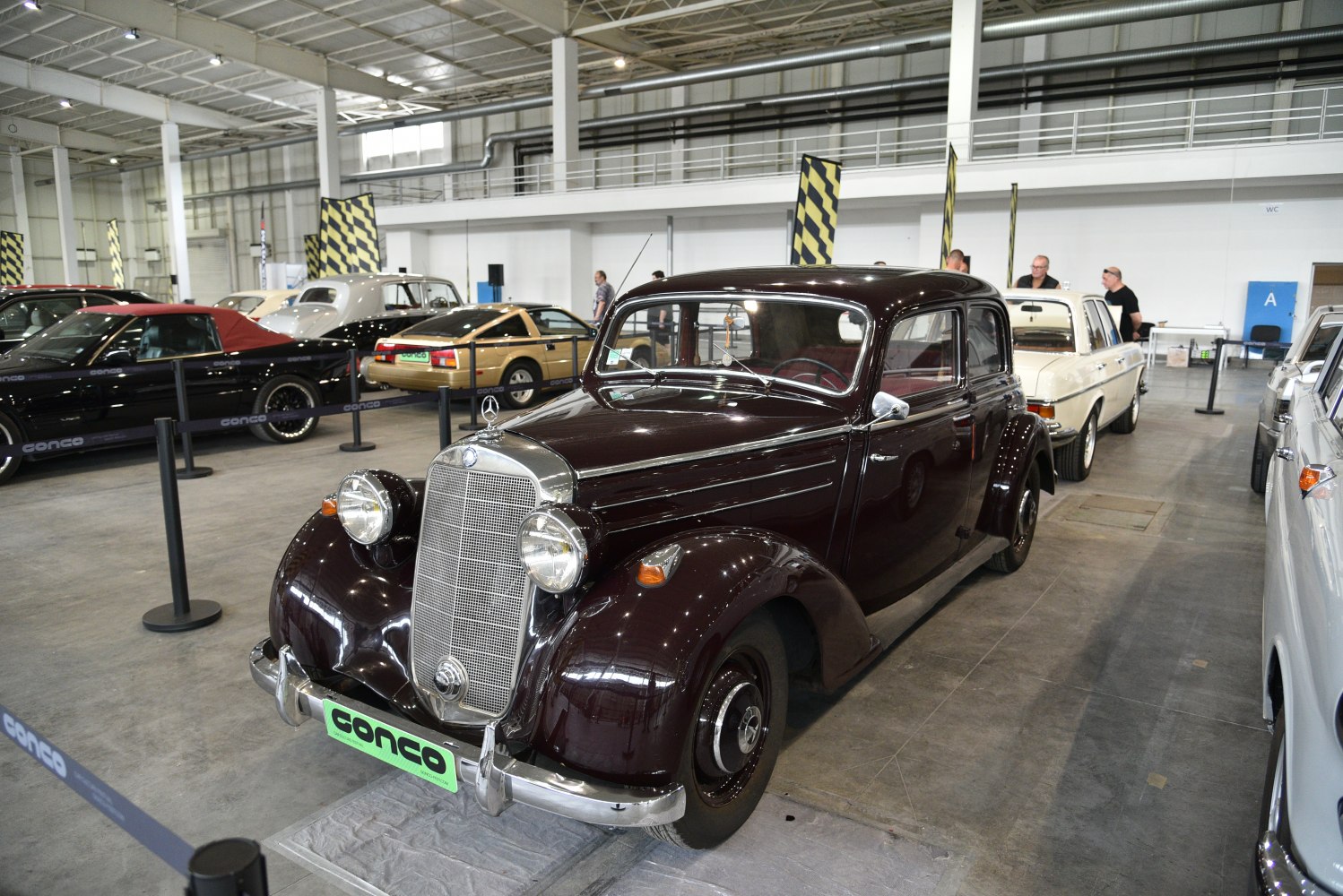 Vintage vehicle with large grille, round headlights, and curved fenders