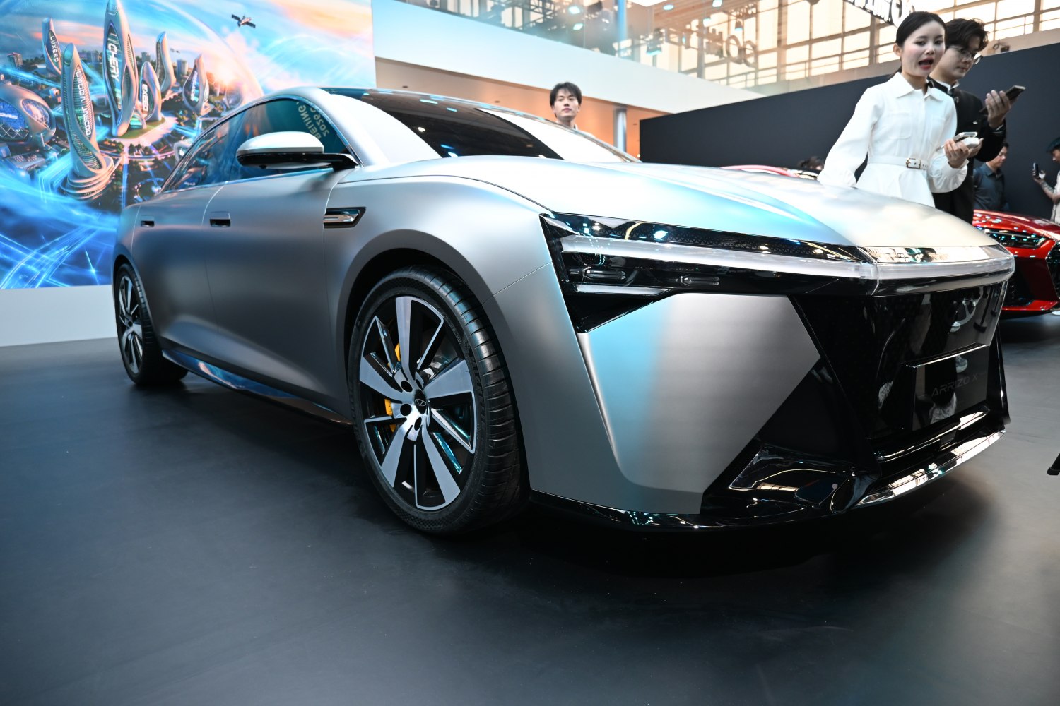 Matte silver futuristic sedan with geometric LED headlights