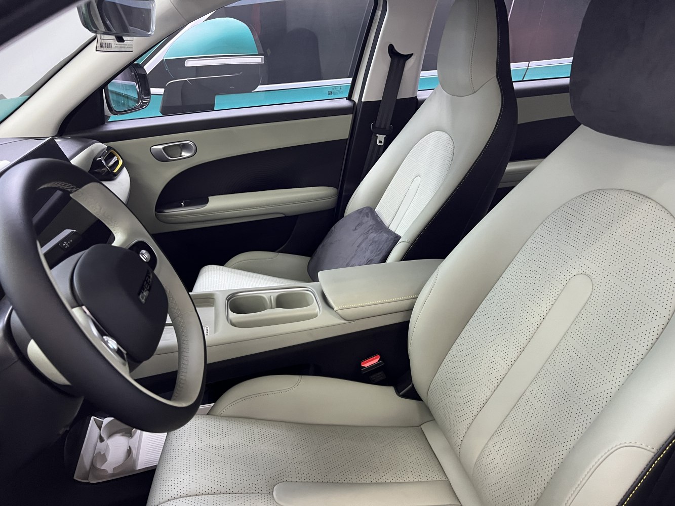Modern perforated leather seats and steering wheel inside a vehicle