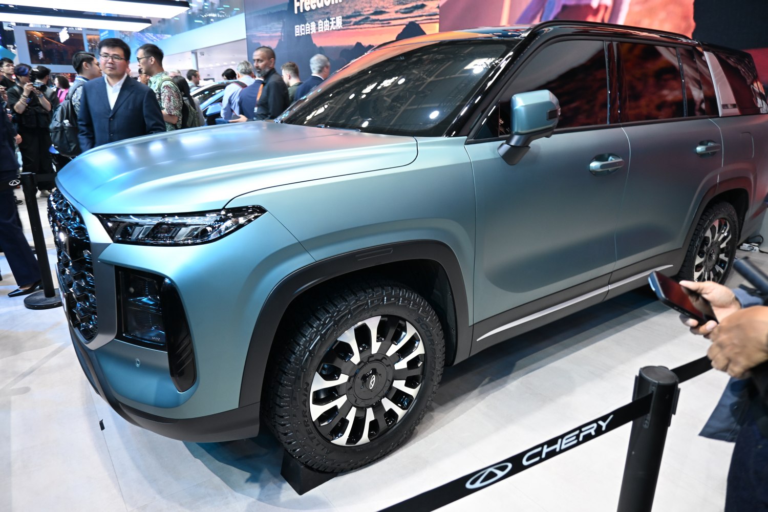 Matte blue SUV with rugged alloy wheels and tinted windows
