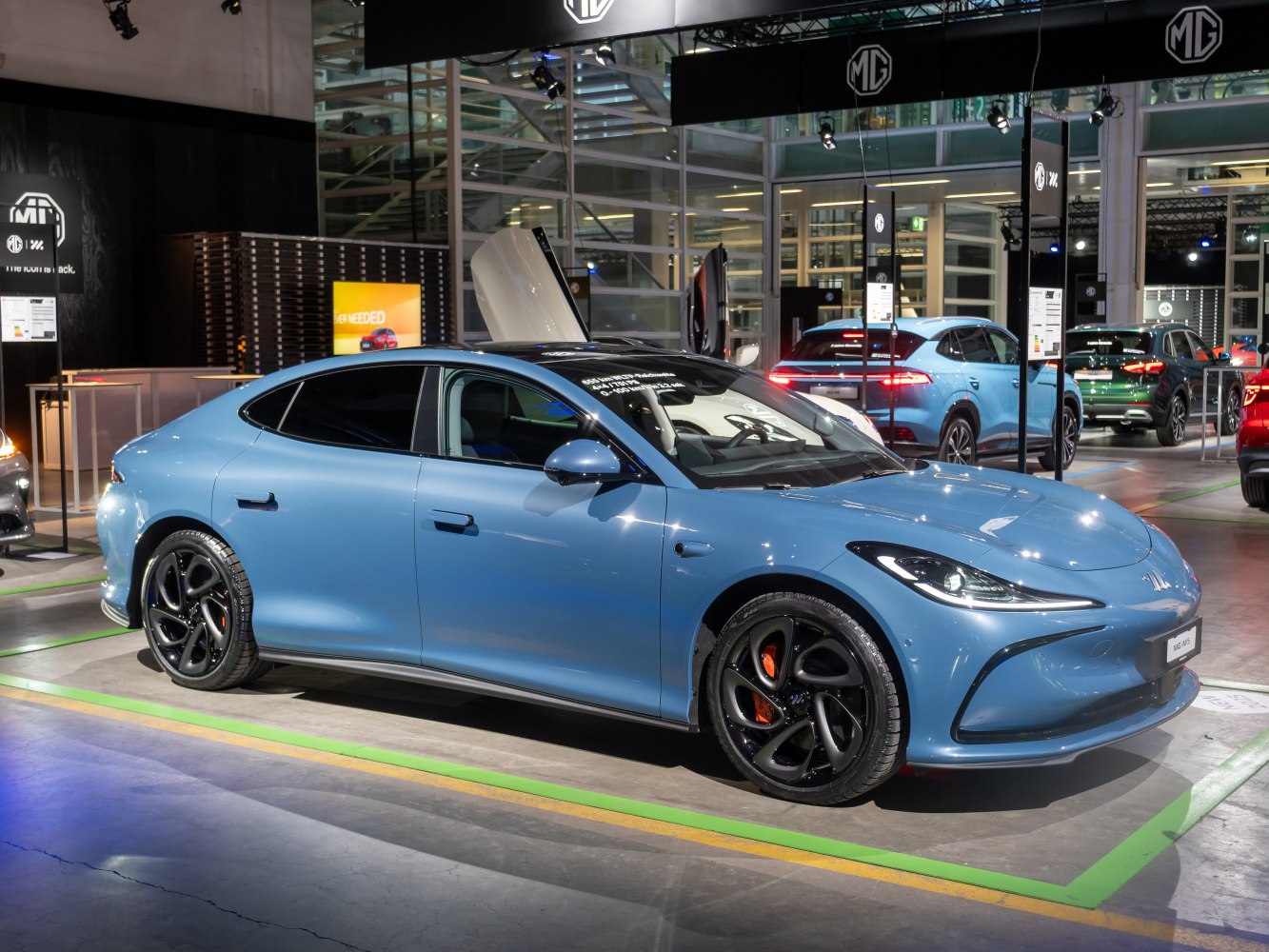 Sleek electric sedan with unique black wheels and orange brake calipers