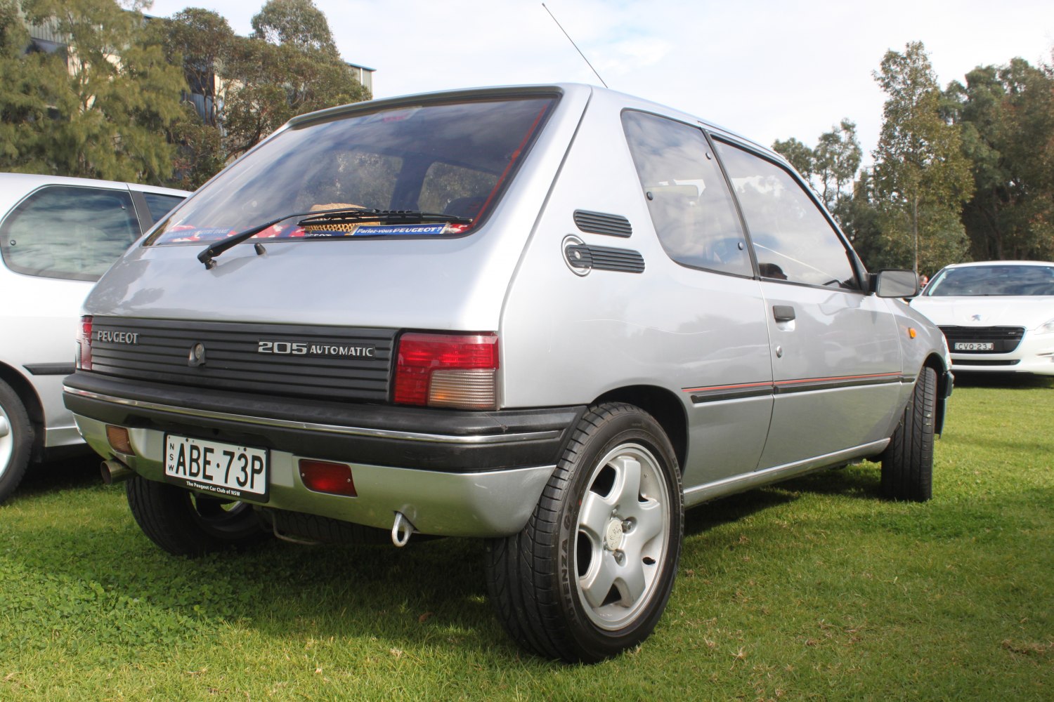 Rear-side view of a silver 3-door hatchback with distinct tail lights and alloy wheels