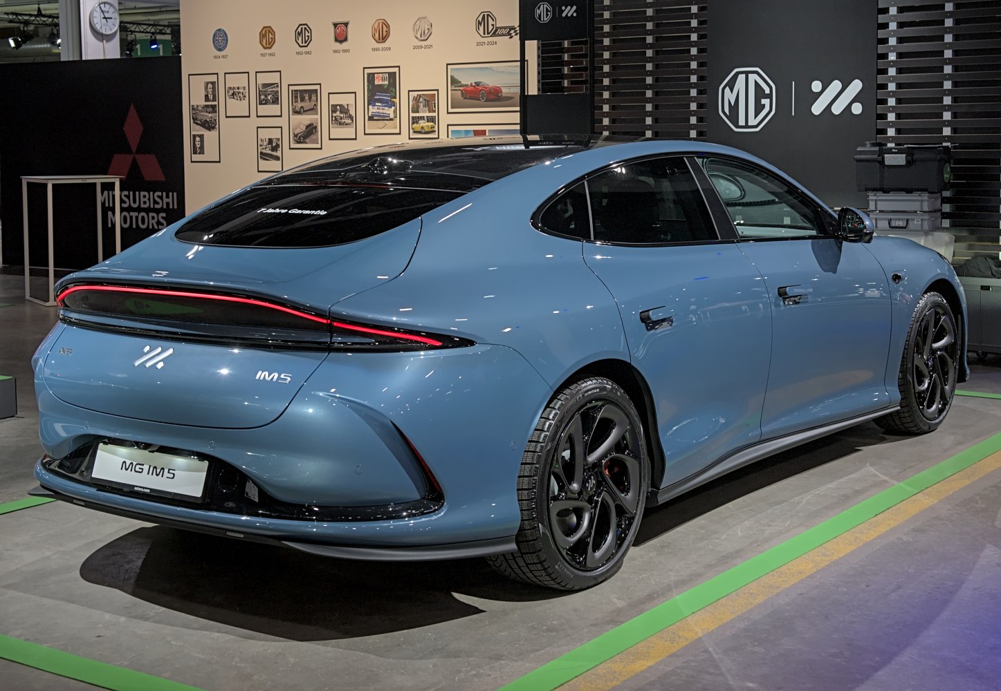 Sleek rear profile with continuous taillight strip and black alloy wheels.