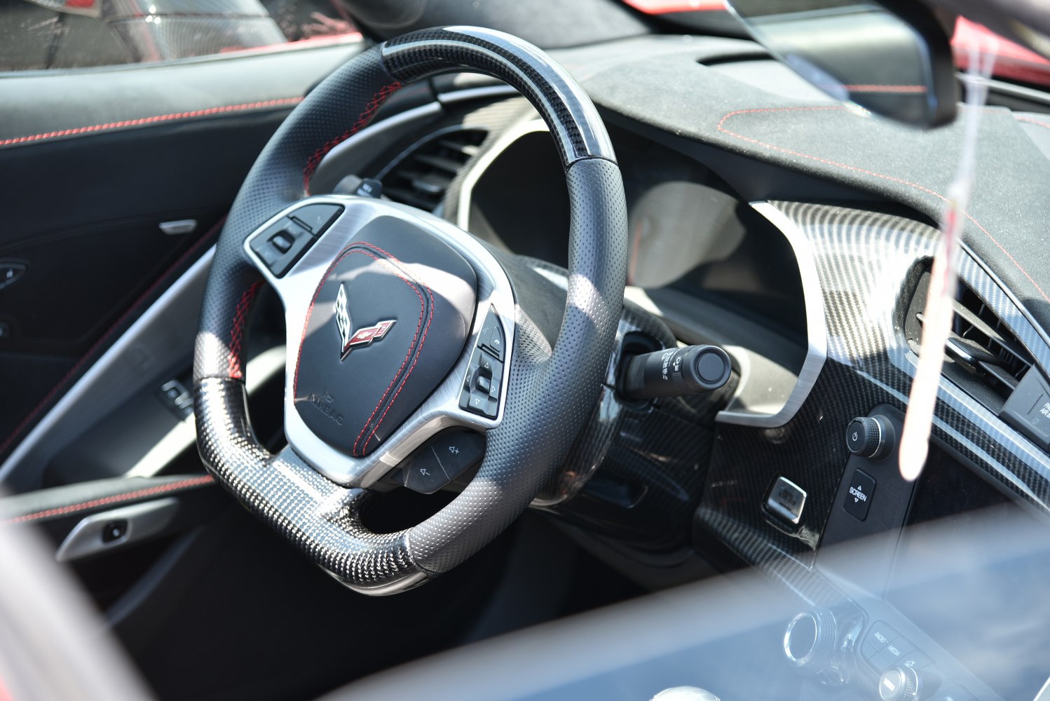 Carbon fiber steering wheel with controls and stitched leather interior