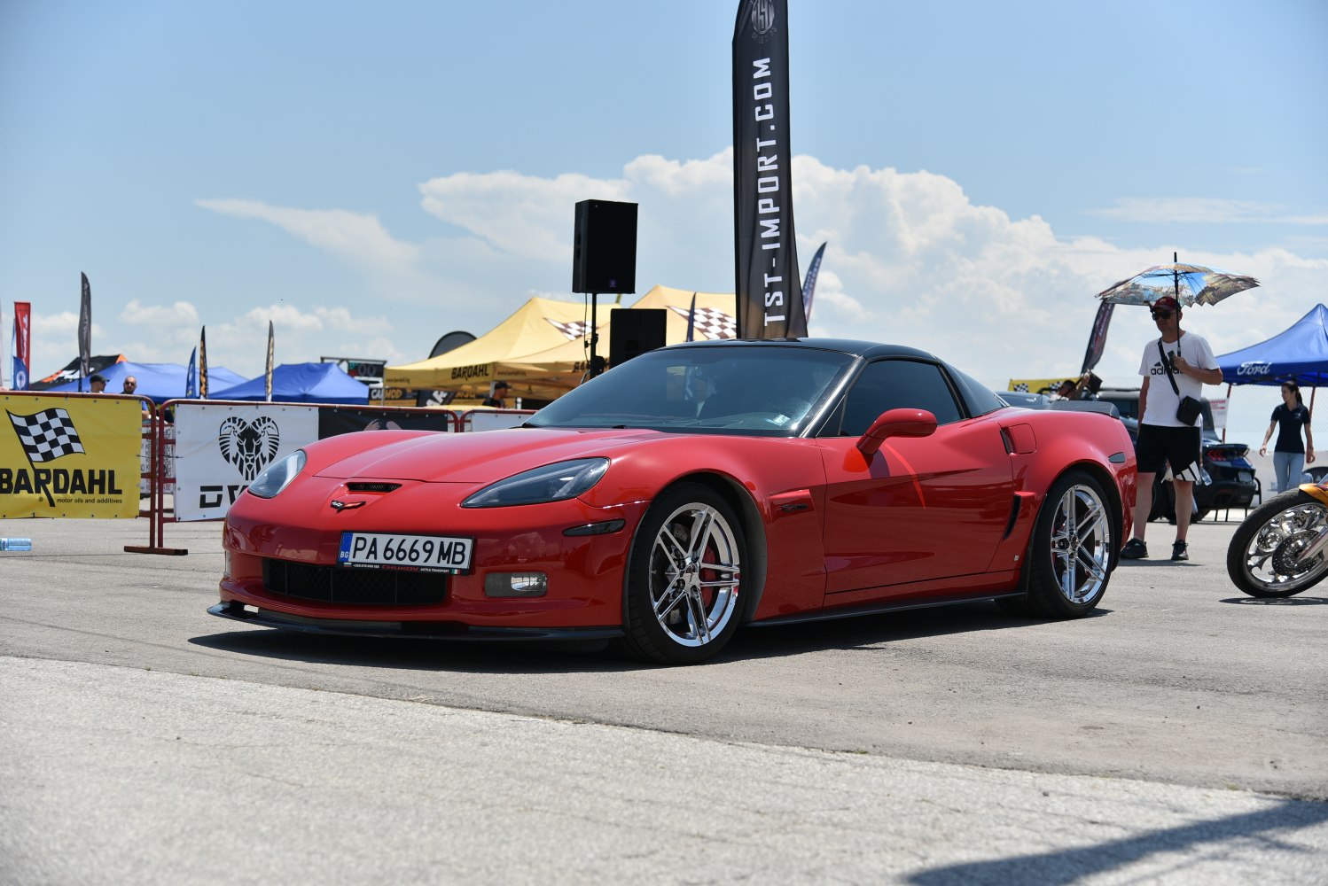 Red sports coupe with chrome wheels and sporty front side profile
