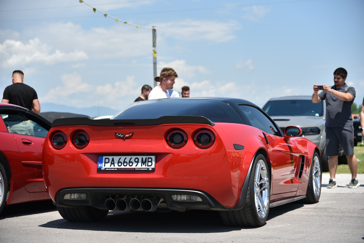 Rear view with quad exhaust pipes and round tail lights