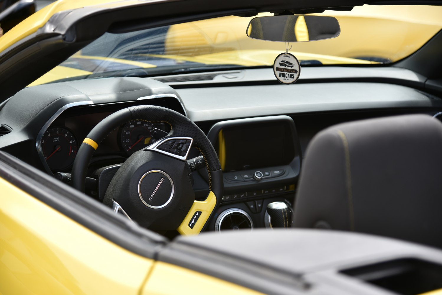 Sporty steering wheel and modern dashboard interior of a convertible
