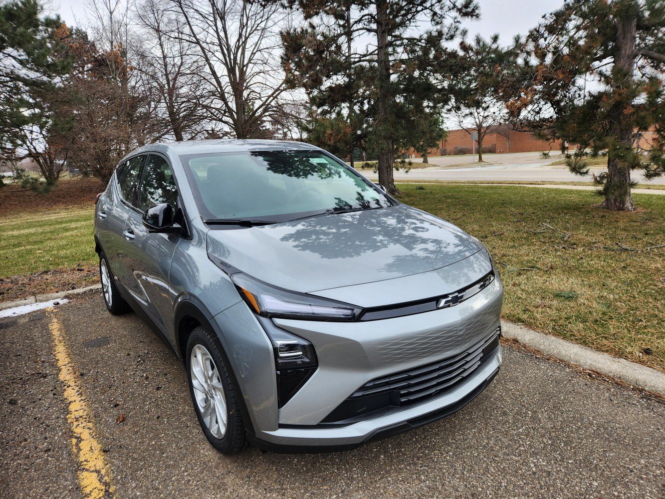 Sleek front design and LED headlights of electric compact SUV.