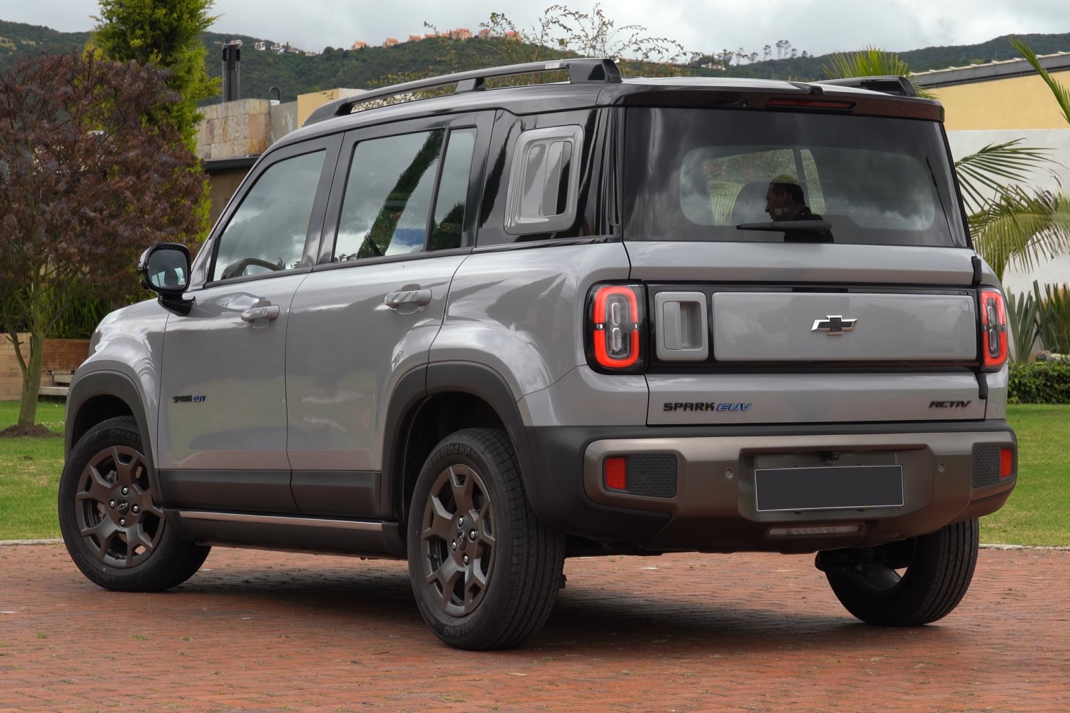 Rear and side view of compact SUV with roof rack and unique taillights