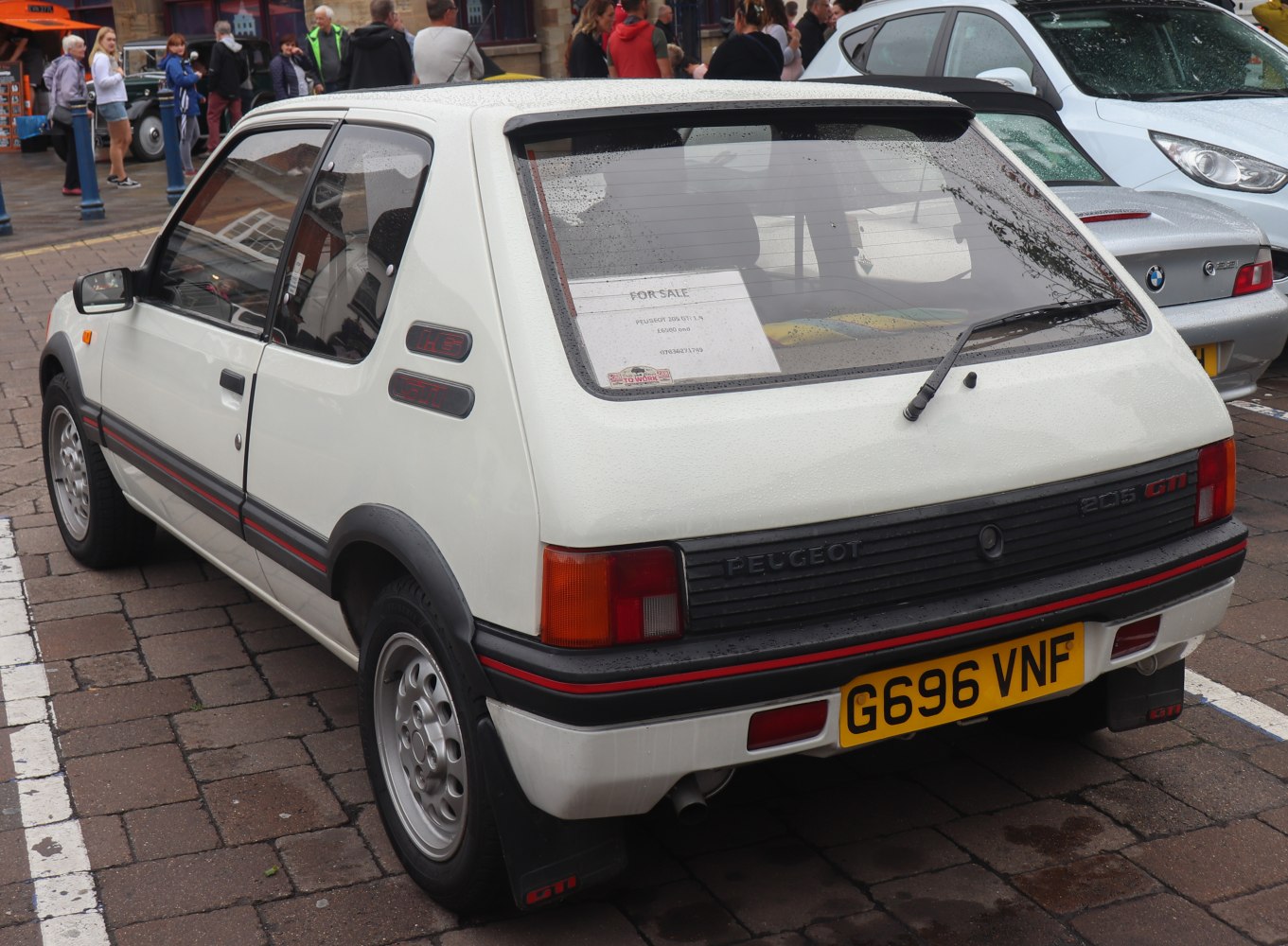 3-door hatchback rear view with rear window wiper and taillights.