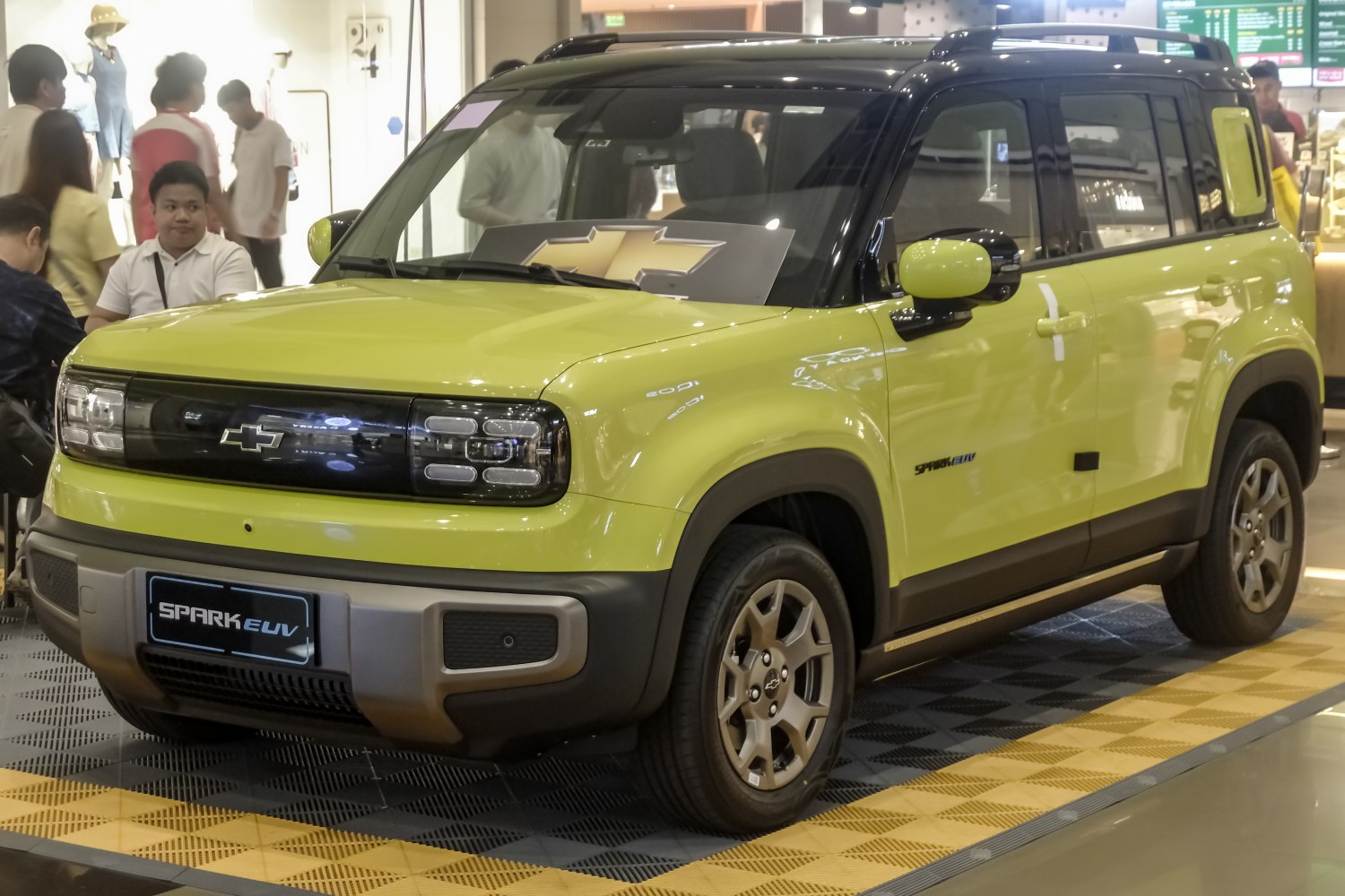 Electric SUV with LED headlights and two-tone black and yellow body