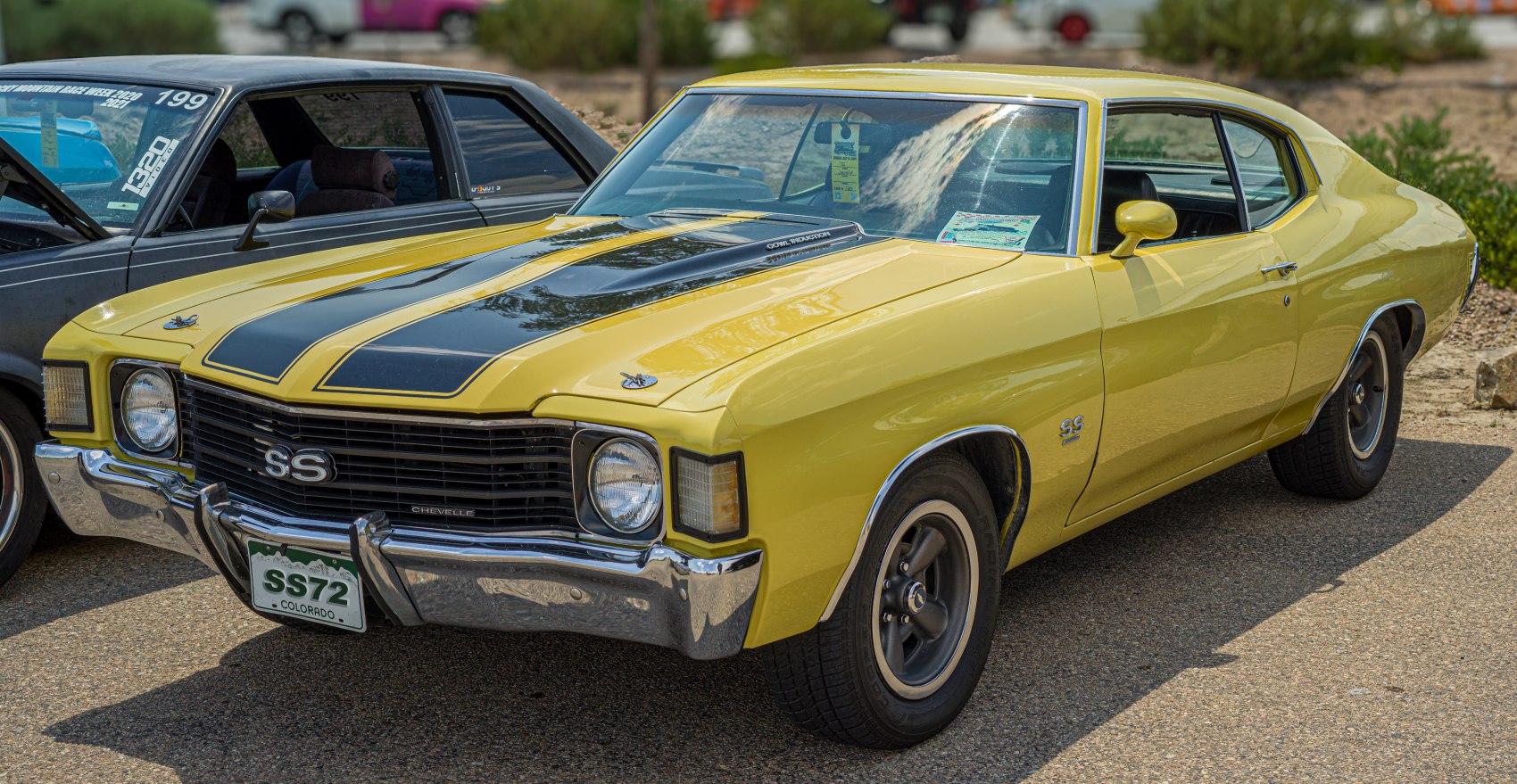 Yellow muscle car with black hood stripes and SS badging