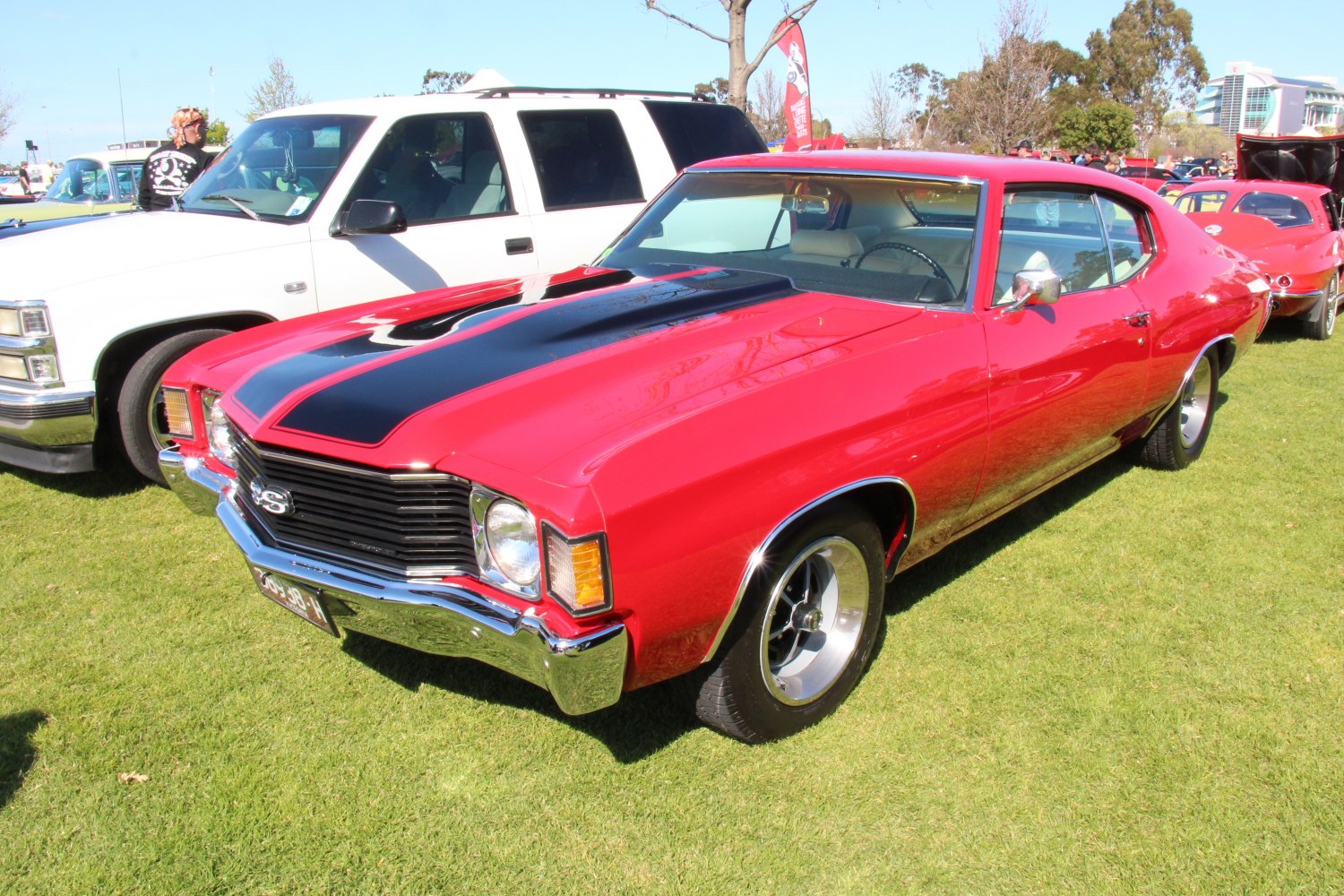 Red 2-door muscle coupe with black hood stripe and SS badge