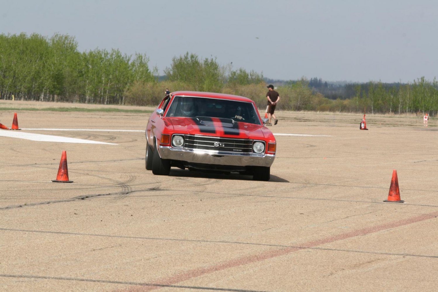Front view of muscle car with racing stripes and SS badge