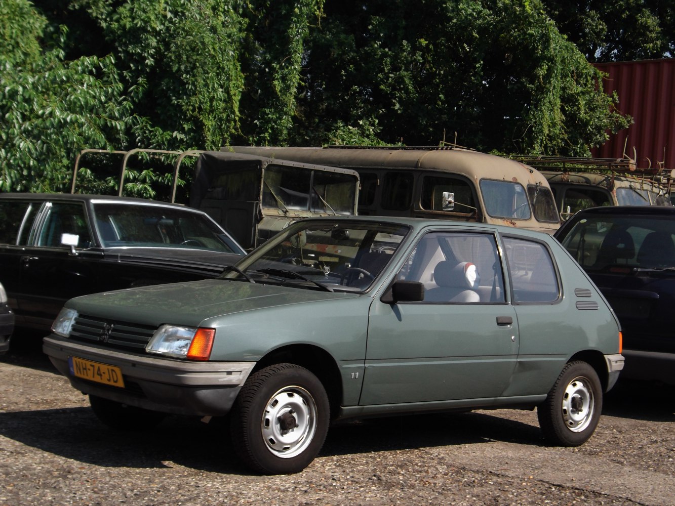 Compact hatchback with slim rectangular headlights and simple steel wheels