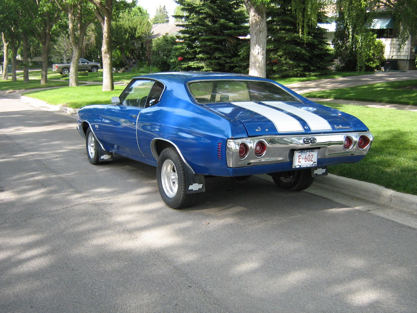 Rear view of 1970s muscle sport coupe with dual racing stripes and round taillights