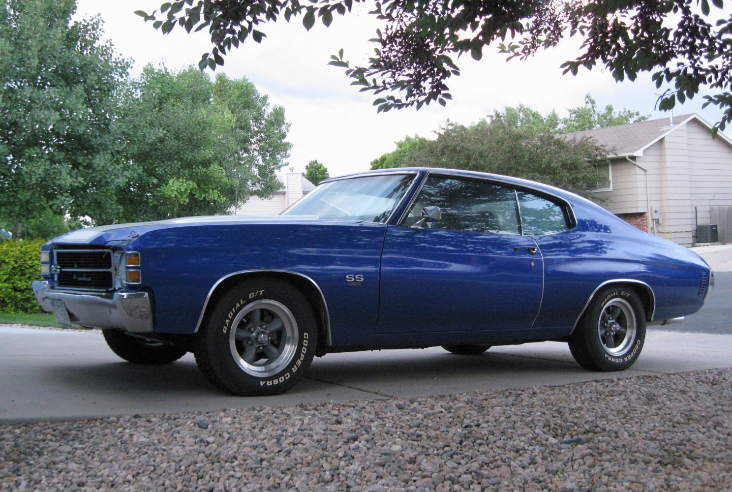 Side profile of a vintage muscle coupe with SS badge and radial tires