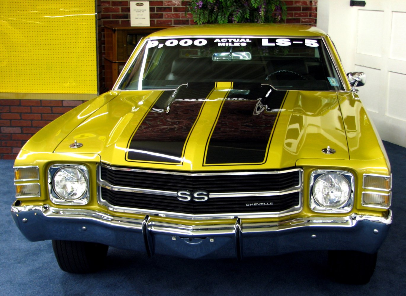 Front view of classic 1970s muscle car with black racing stripes and chrome grille