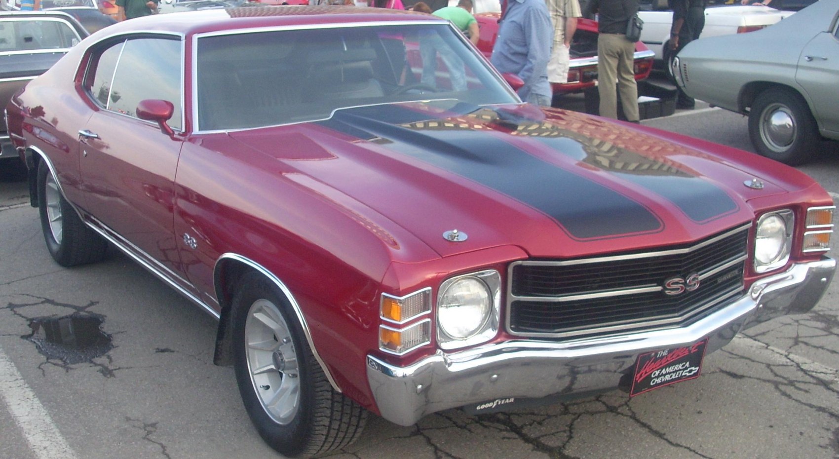 Front view of muscle car with black hood stripes and SS badge