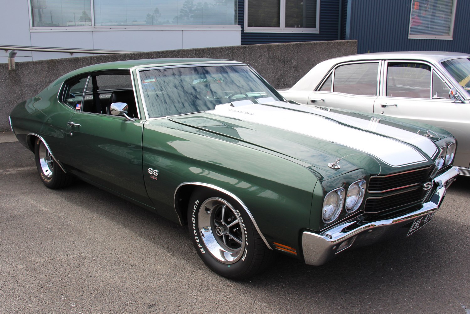 Green muscle coupe with white racing stripes and chrome bumpers