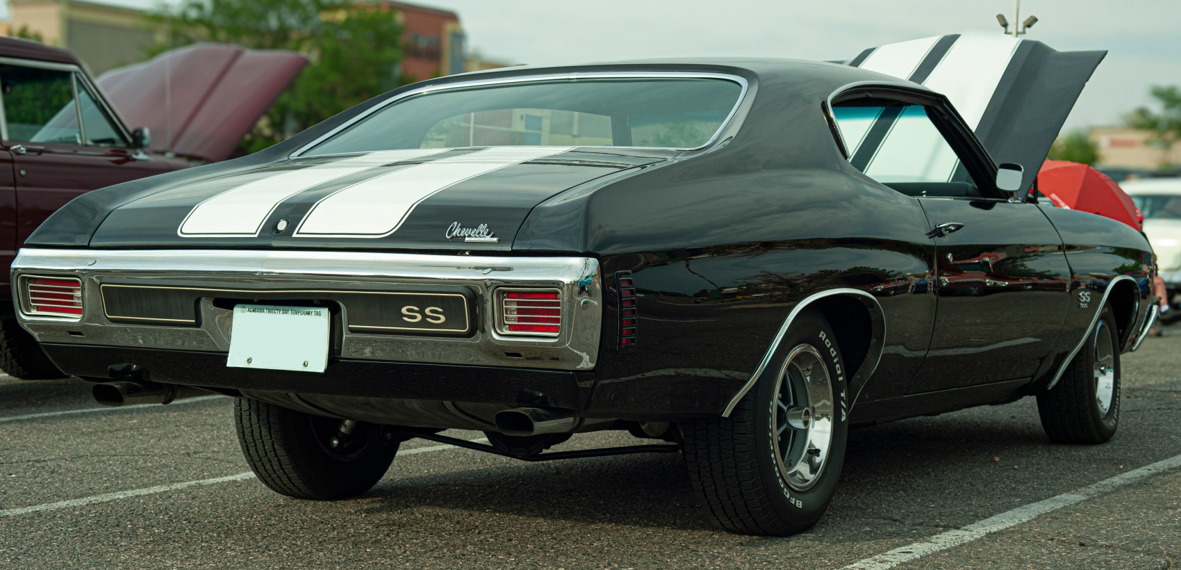 Rear view of a muscle car with dual racing stripes and SS badge