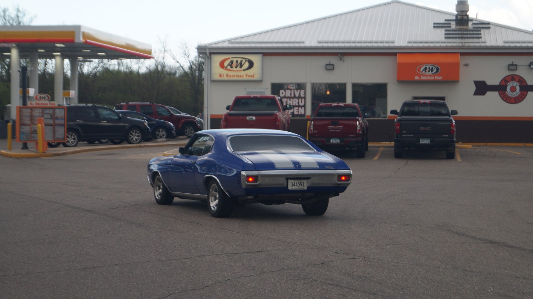 Rear view of muscle coupe with white racing stripes